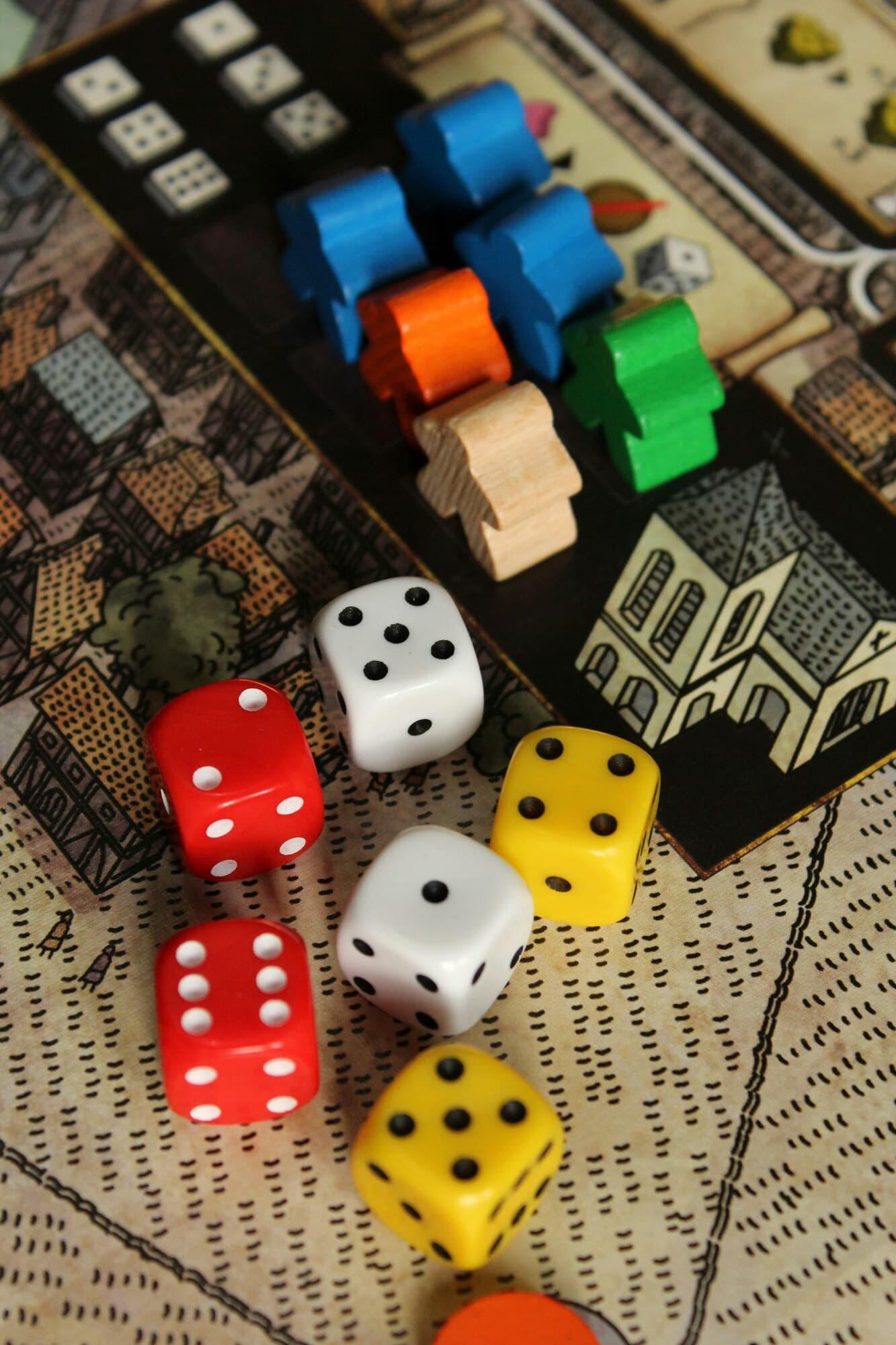 Dice with person pieces next to it